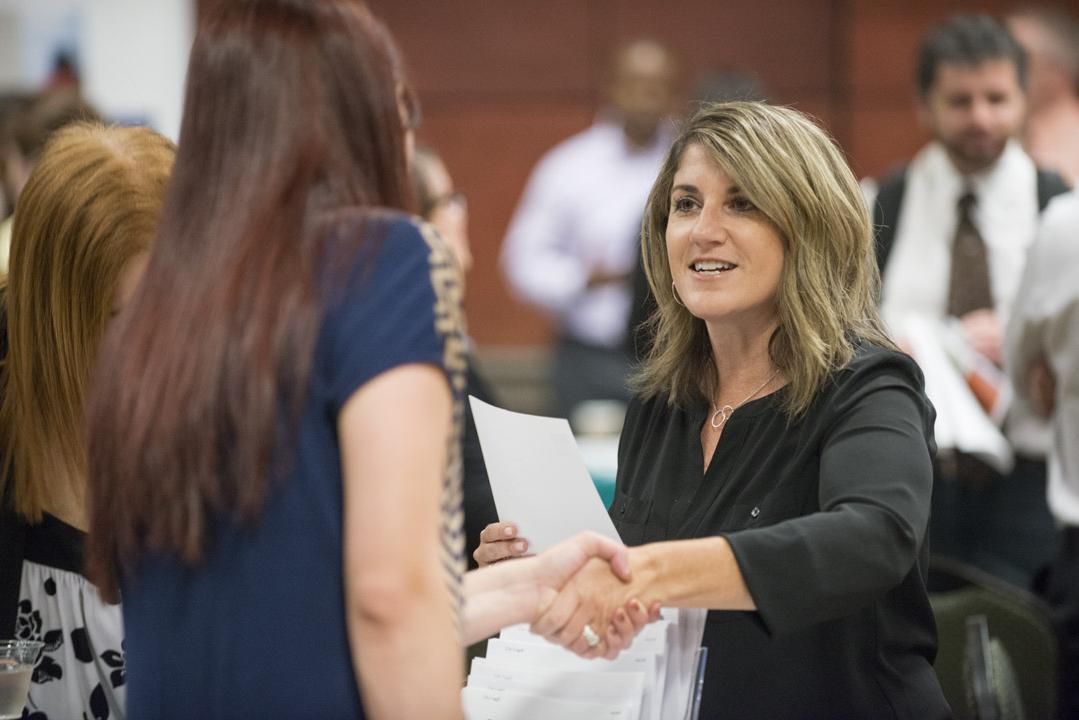 Woman introduces herself at a networking event.