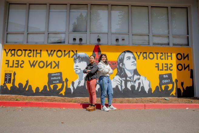 Julie Crumb and Alejandra Ruiz in front of Becoming Mural